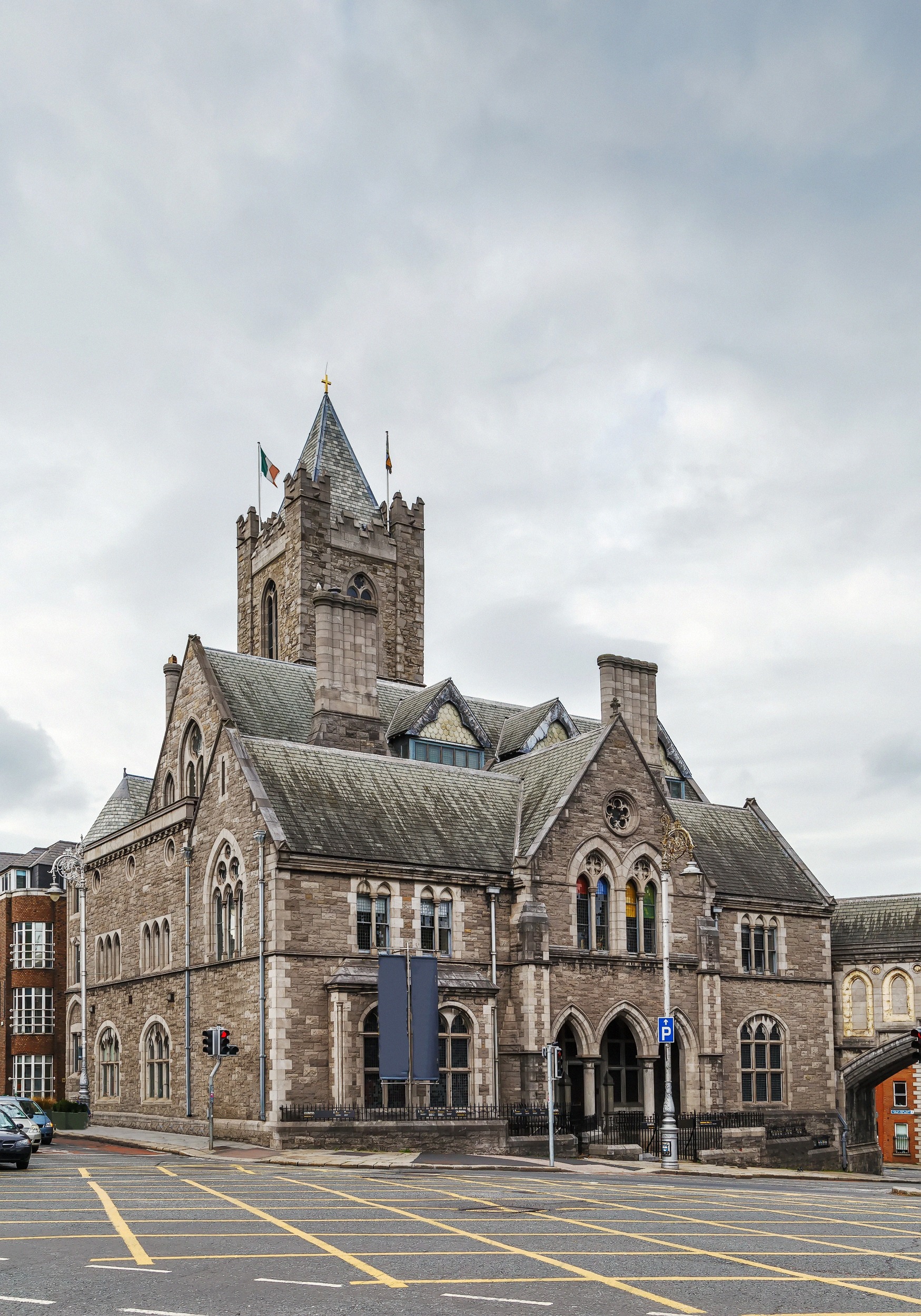 The brick building of Dublinia / Synod Hall with its round crenellated tower next to Christ Church Cathedral.